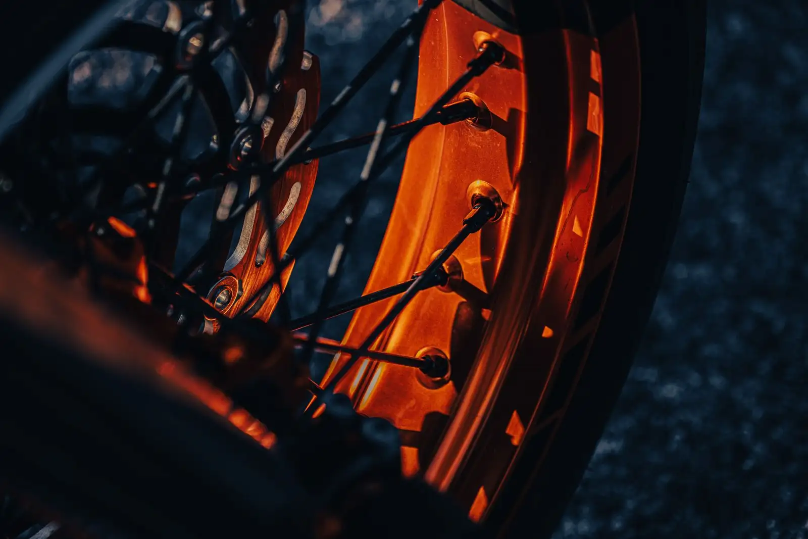 Motorcycle wheel in dramatic orange light