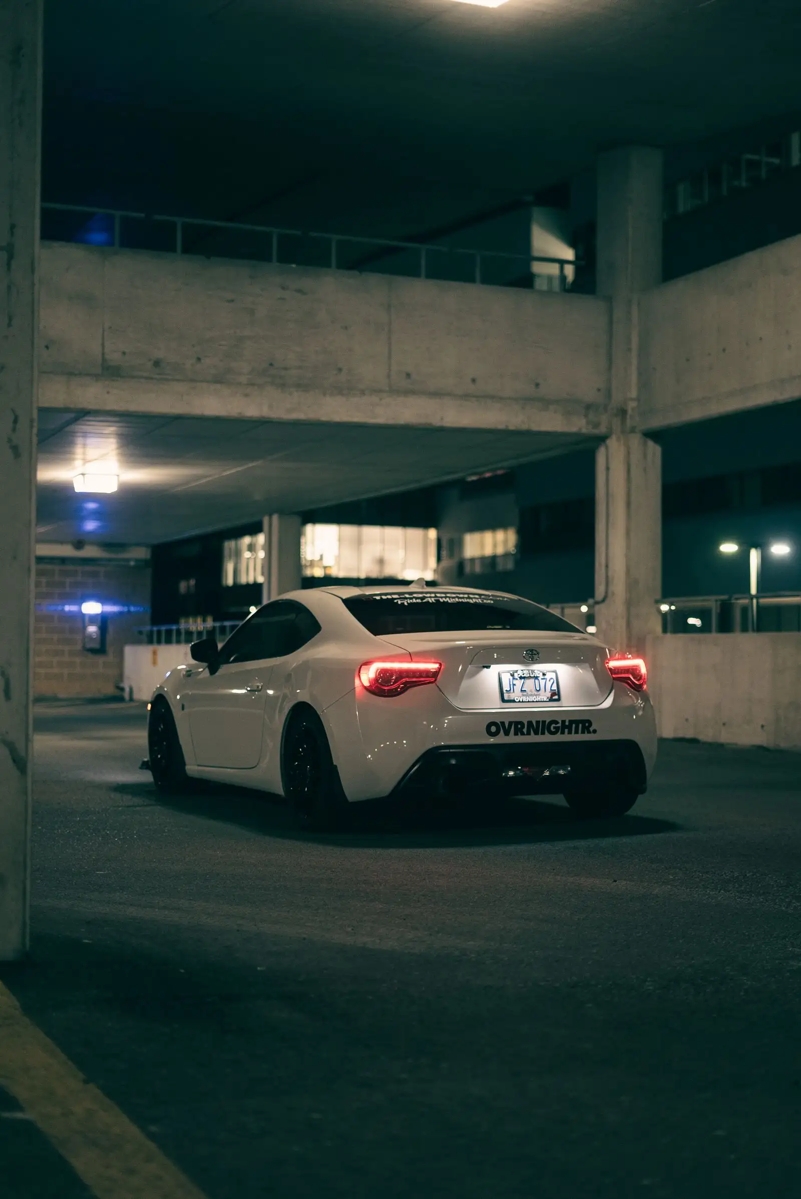 Sports car in a parking garage at night