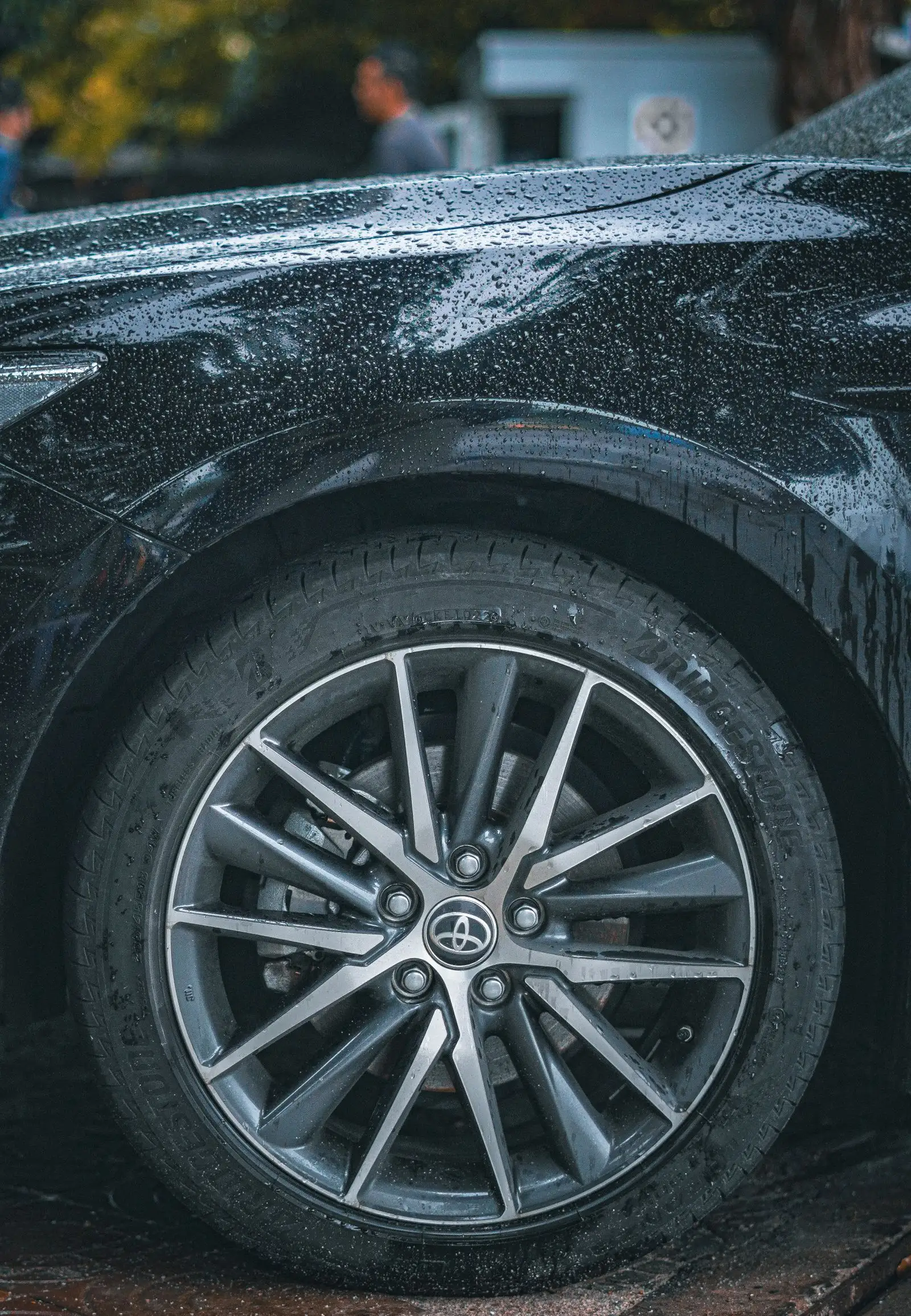 Tire and wheel arch with rain droplets